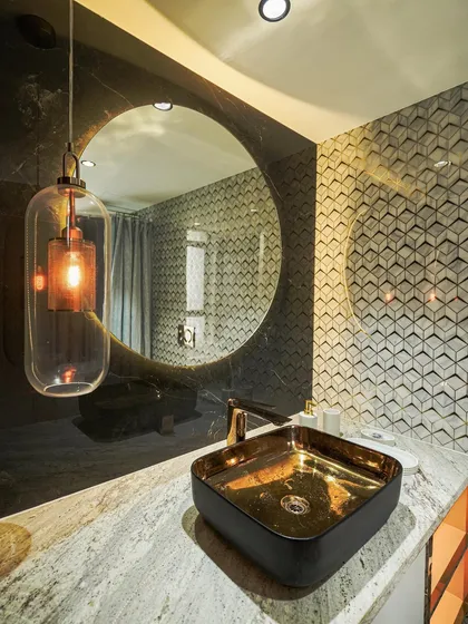 Luxury is found in the details. In this washroom renovation, I combined a bold, gold-leafed basin with dramatic 3D tiles and a statement pendant light. It creates a personal retreat that feels both opulent and modern.