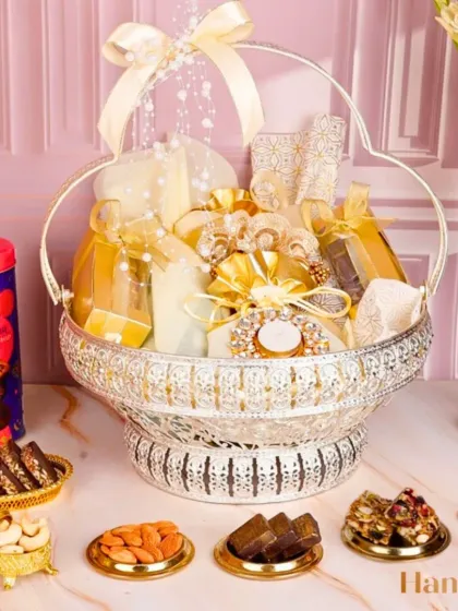 The Tejomay Hamper is a sparkling symphony of taste and tradition. The ornate silver basket is filled with an assortment of my finest sweets and savories, crafted for those who love to celebrate in style.