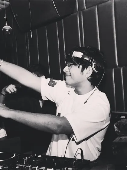 A black and white shot of me dancing behind the decks. I can't help but move to the music I play.