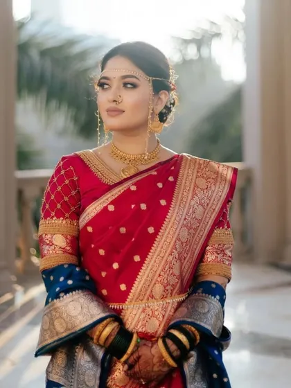 A regal portrait of our Maharashtra bride. The lighting beautifully captures the details of her saree, jewelry, and our subtle, enhancing makeup.