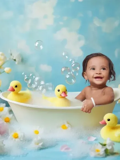 Pure joy in a tub. This is an example of a fun and creative baby photoshoot, complete with bubbles, rubber ducks, and a beautiful floral setup. I ensure your baby is comfortable and happy throughout these playful sessions.
