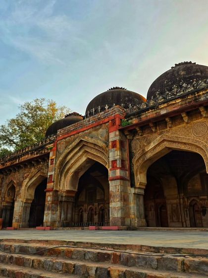 The beautiful arches of a monument in Lodi Garden, captured during the golden hour. The play of light and shadow highlights the intricate details of the architecture.