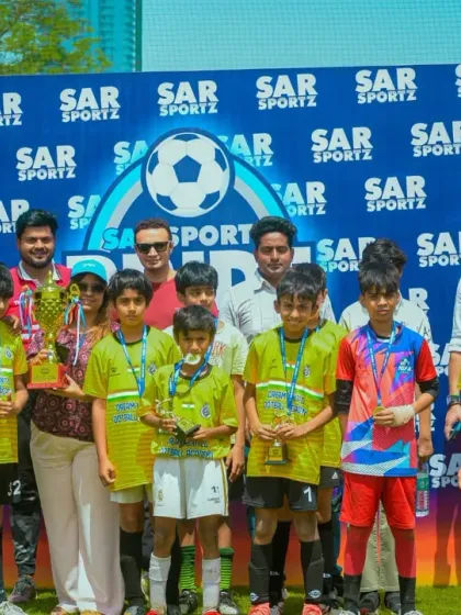 A winning team poses with their coaches and supporters, celebrating their victory at the Pride Cup.