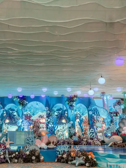 A wide view of the incredible 'Under the Sea' stage. The layered props, wave-like ceiling treatment, and professional lighting create a truly theatrical and immersive environment.