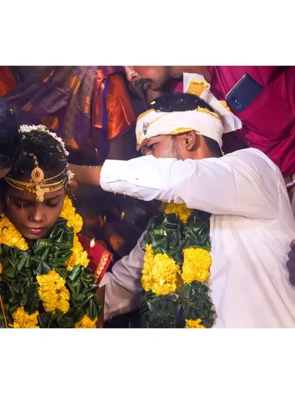 A close-up shot of a key wedding ritual. The groom is applying the kumkuma, and I framed this tightly to focus on the tradition and the expressions of the couple, surrounded by their loved ones.