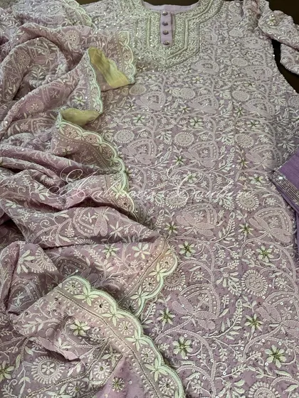 This image captures the flow and texture of the pure georgette fabric, covered in dense Chikankari jaal.