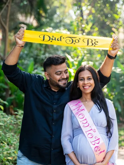 Announcing their new roles with pride. This fun shot with "Mom to Be" and "Dad to Be" sashes is a great way to celebrate the journey to parenthood.