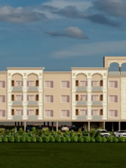 This is the architectural rendering for NRI Niwas, a residential building near Gurudwara Fateh Nagar. The design blends modern apartment living with traditional Indian architectural motifs, like jaali work and arched balconies, to create a culturally rooted yet contemporary facade.