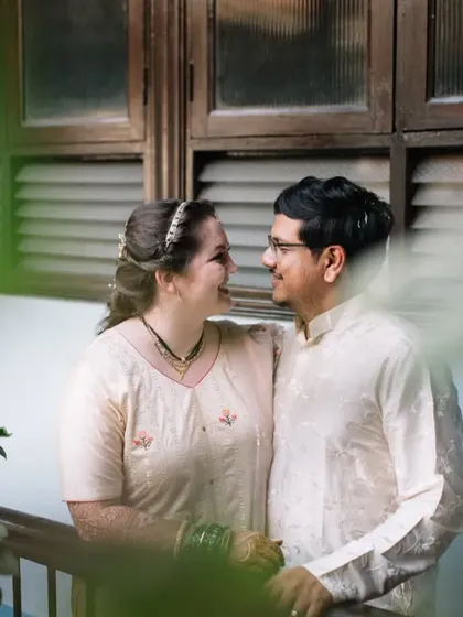 A sweet, intimate portrait of Jessie and Purujit, framed by the leaves of a plant in their home. Shooting in a place that means so much to the couple adds an extra layer of meaning to the photos.