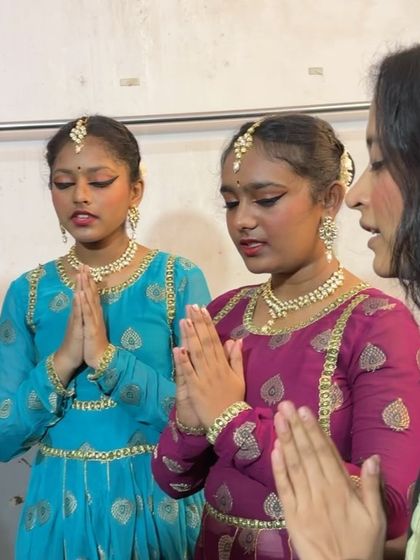 A behind-the-scenes moment, sharing a quiet prayer with my students before they go on stage, a special part of our pre-performance ritual.
