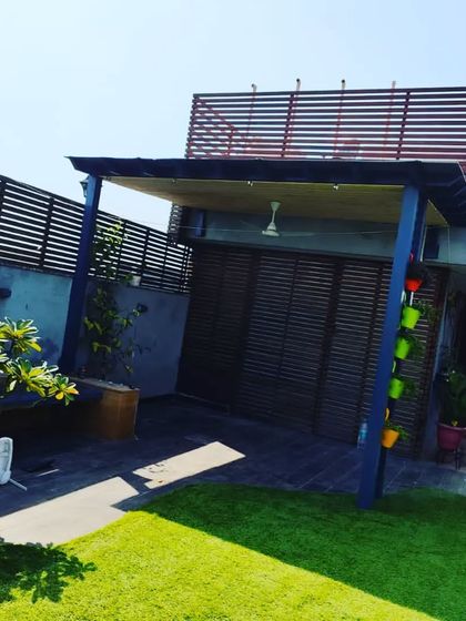 This view shows the entire structure, including the privacy screen in the background, creating a cohesive and functional outdoor space.