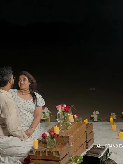 Capturing the happy couple during their private beach proposal. Our setup provides a beautiful and intimate setting for photos, with the soft glow of candles and the ocean in the background.