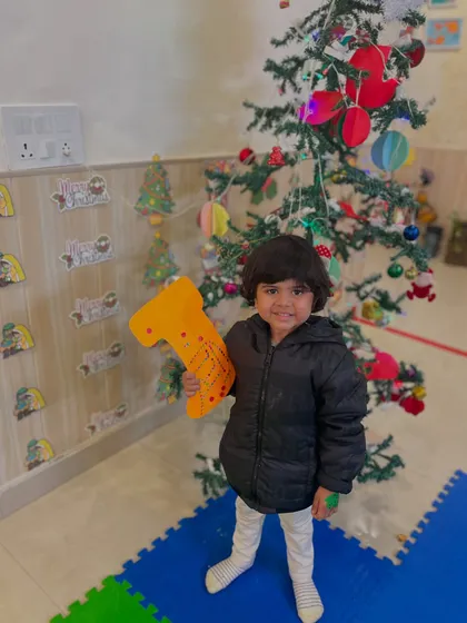 This little one is all smiles as he poses with his decorated stocking.