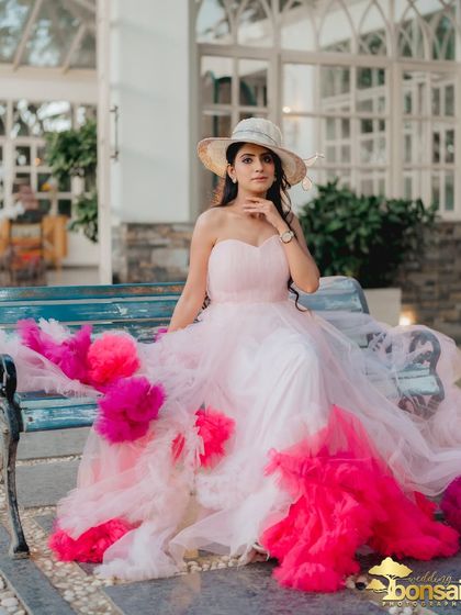 A solo portrait of the bride, looking chic and stylish in her dramatic gown and hat. This showcases the high-fashion potential of a pre-wedding shoot.