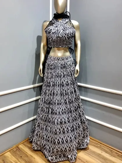 A black and white printed crop top and skirt set. This Indo-Western outfit is perfect for a guest who wants a comfortable, stylish, and modern look.