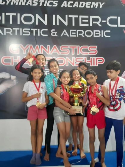 More moments of triumph from various competitions, showcasing our gymnasts with their medals, trophies, and proud coaches.