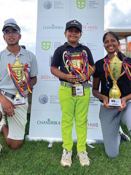 Three of our champions with their trophies. Their success is a direct result of the structured, high-performance system we have in place.