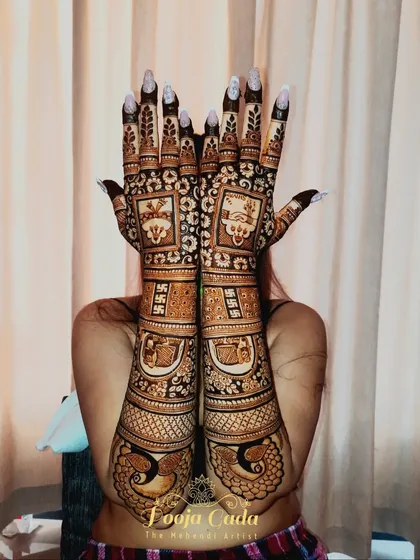 A heavy bridal back-hand design for a bride from Pune, featuring intricate patterns and traditional symbols.