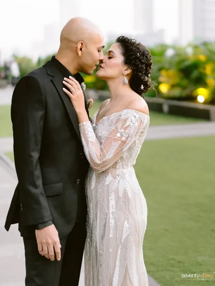 A tender kiss between the bride and groom, a classic and timeless portrait from their interfaith wedding celebration.