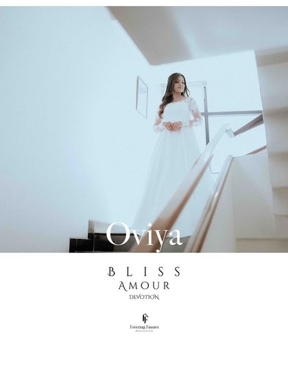 A serene portrait of a Christian bride in her white gown, standing on a staircase.