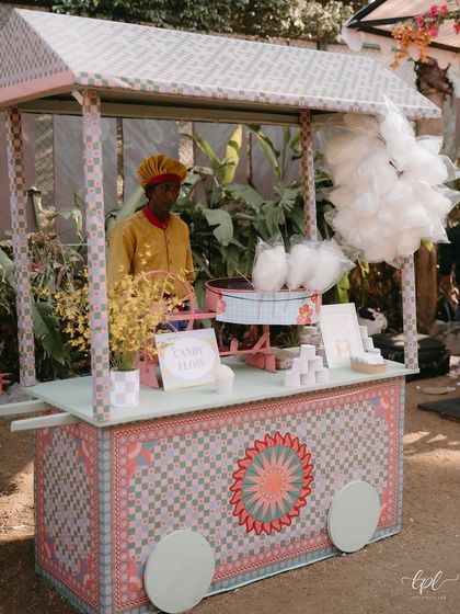 A beautifully designed cotton candy cart, adding a touch of sweet nostalgia and fun to the carnival-themed celebration.