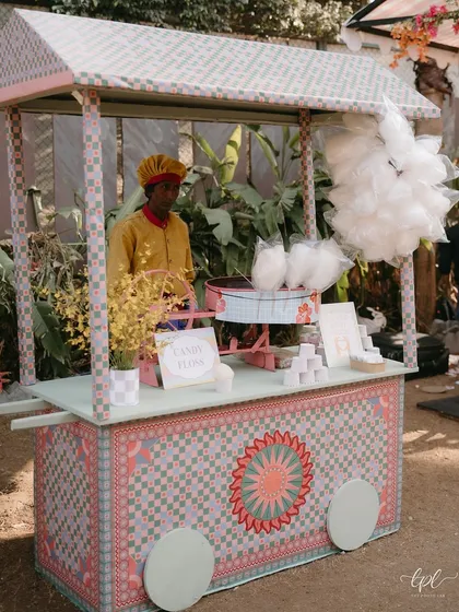 A beautifully designed cotton candy cart, adding a touch of sweet nostalgia and fun to the carnival-themed celebration.