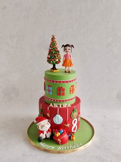 A Christmas-themed birthday cake for Akira's 8th birthday, with Santa, a Christmas tree, and lots of presents.