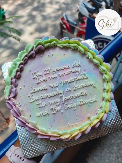 A cake for my own birthday, featuring a famous quote from Pride and Prejudice. The pastel rainbow frosting and delicate piping create a beautiful backdrop for the humorous, self-aware text.