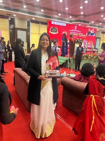 Holding the 'Durga' award I received at the International Women Summit. A proud moment for me and my foundation.