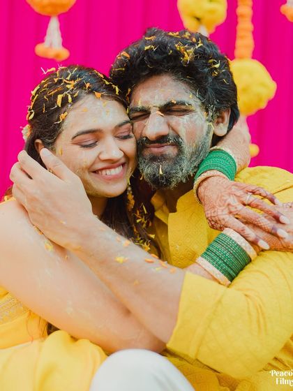A heartfelt hug amidst the Haldi chaos. This shot captures the couple's deep affection and the overwhelming joy of the moment.