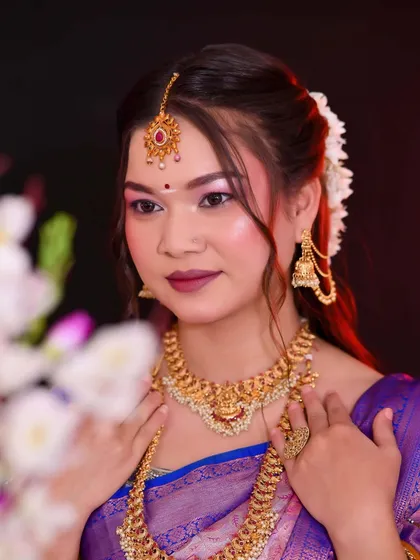 A close-up shot of the South Indian bride, focusing on the flawless makeup and intricate jewelry.