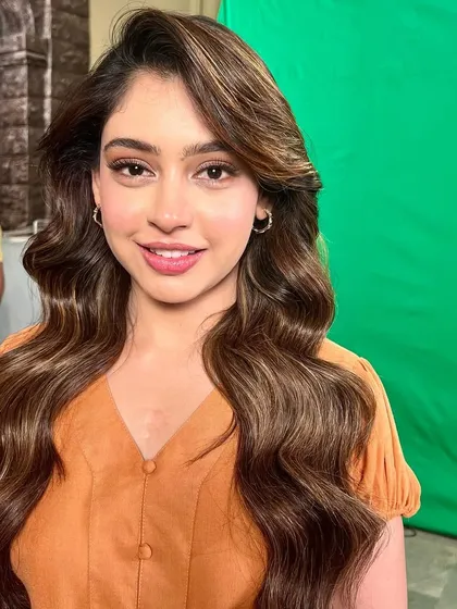 A happy, smiling shot of Niti, showcasing the natural-looking makeup that is perfect for any daytime event.