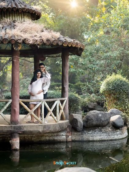 This park gazebo created such a lovely frame for this couple's portrait. The golden hour sunlight filtering through the trees added a warm, magical glow to this beautiful outdoor maternity shot.