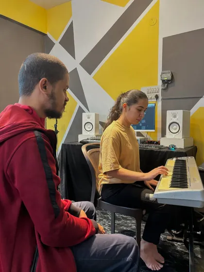 A student receives personalized instruction during a keyboard class at our Kaggadasapura branch, which features a modern and inspiring learning space.