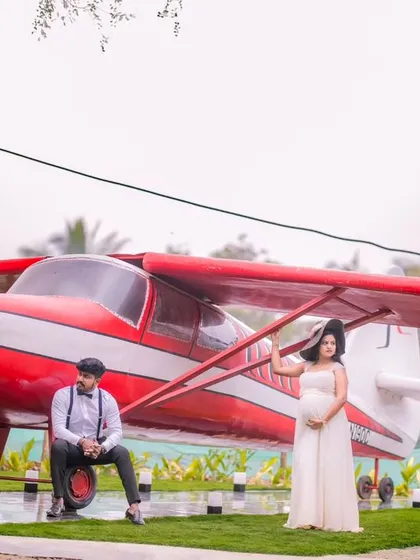 Another angle of the maternity shoot with the airplane, showcasing the expecting mother.