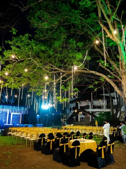 The stage is set for a night of celebration. This wide shot captures the beautiful outdoor decor for a cocktail night under the stars.