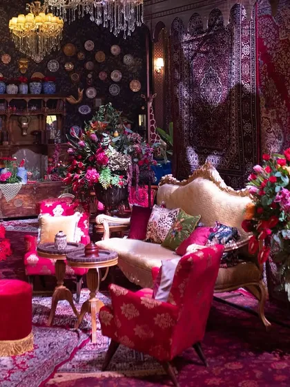 This angle captures the sheer density of the decor, with layers of rugs, furniture, florals, and wall art all working together to create a truly maximalist and immersive guest experience.