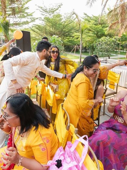 The Haldi ceremony is all about fun and family. This photo captures the joyful chaos as guests playfully apply turmeric to the couple.