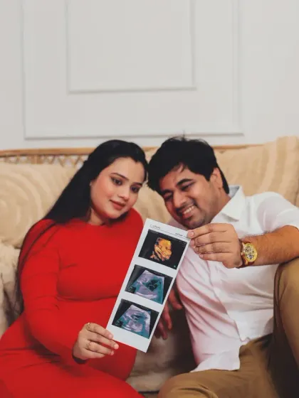 Incorporating personal items makes a shoot special. Here, the couple proudly displays their baby's first pictures, the ultrasound scans, making it a centerpiece of their themed session.