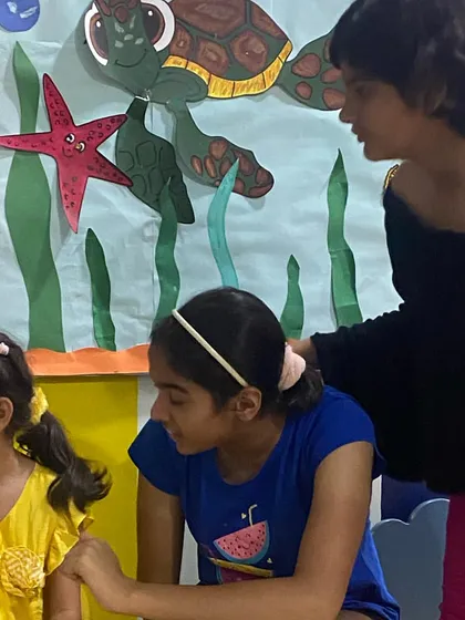 A group of students engaged in a lively discussion. Process-based theatre is all about collaboration and sharing ideas to create something together.