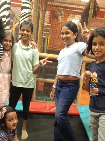 A group of friends posing on the trampoline. It's not just for jumping; it's a place where kids can hang out and make memories together.