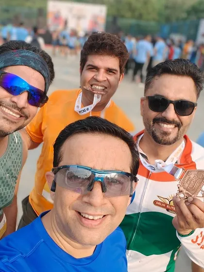 A fun selfie with one member biting his medal. We have a lot of fun celebrating our achievements.