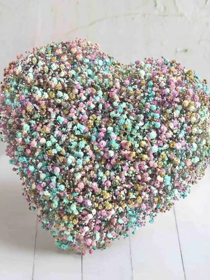 A unique heart-shaped arrangement made entirely of colourful baby's breath. A modern and whimsical way to say "I love you."