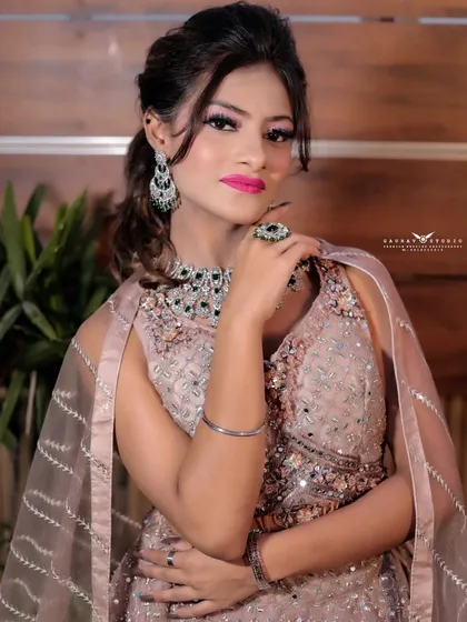 A confident pose, with the model's hand on her hip, showcasing the full glamour of the look.