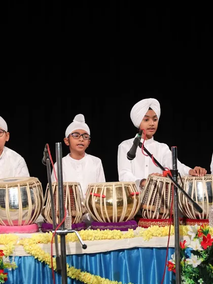 A group of our tabla students on stage, ready to begin their performance at the annual concert.