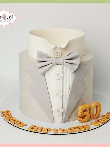A dapper tuxedo cake for a 50th birthday. This sophisticated design is perfect for a gentleman's milestone celebration, featuring a clean and elegant suit-and-bow-tie look.