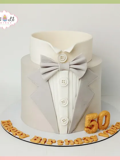 A dapper tuxedo cake for a 50th birthday. This sophisticated design is perfect for a gentleman's milestone celebration, featuring a clean and elegant suit-and-bow-tie look.