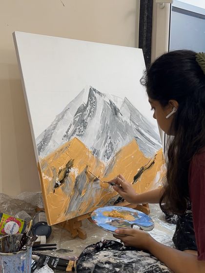In the zone, painting an abstract mountain landscape. I use a palette knife here to apply thick layers of paint and create a rugged, textured surface.