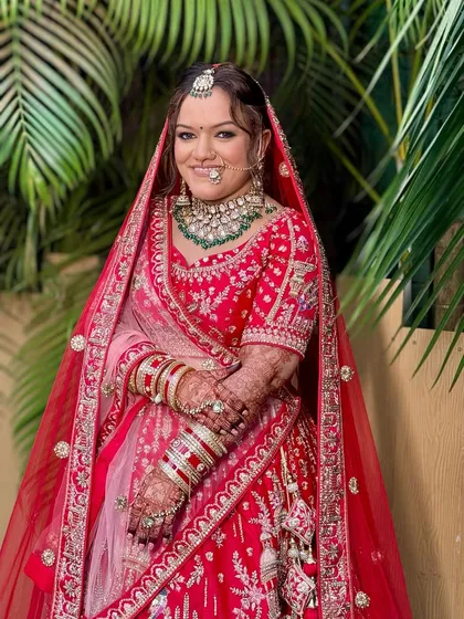 This full-length shot shows how the complete look comes together. The makeup, hair, and outfit create a vision of timeless bridal elegance.
