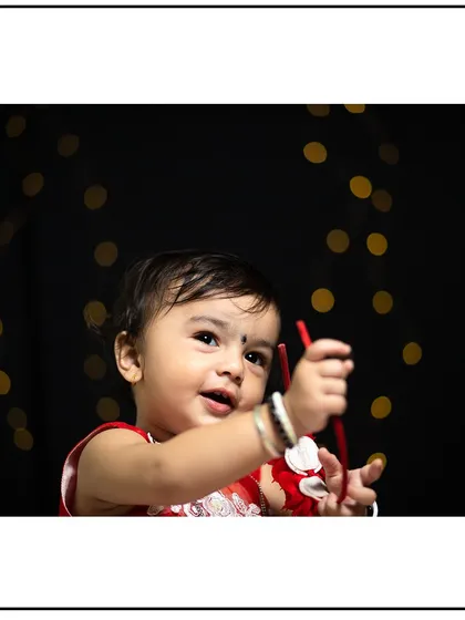 Capturing a moment of playful curiosity in the studio. The string lights in the background add a touch of warmth and magic.